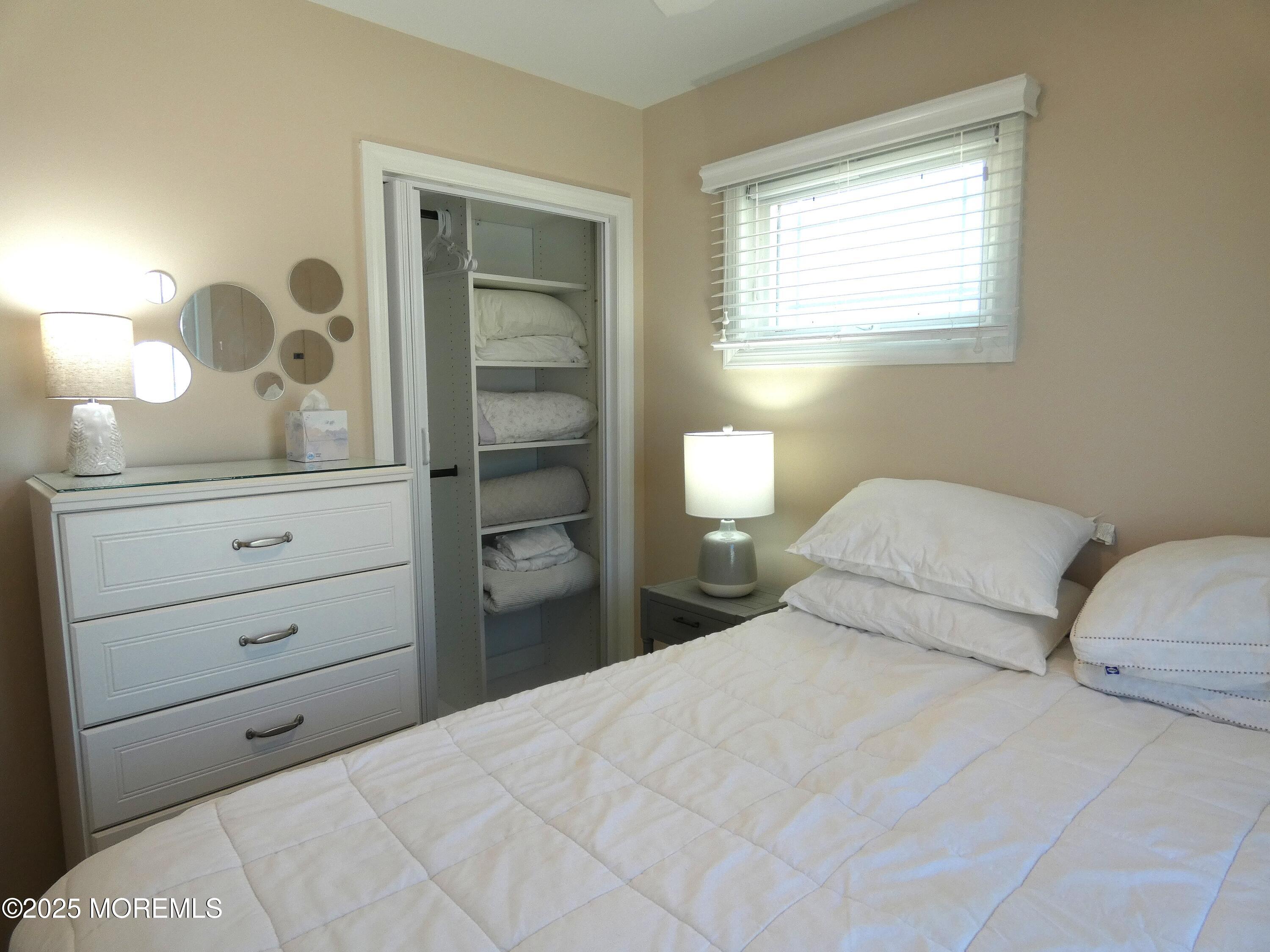 3420 Seaview Road Lavallette, NJ 08735 - Photo 21 of 44 a bedroom with a bed and a dresser