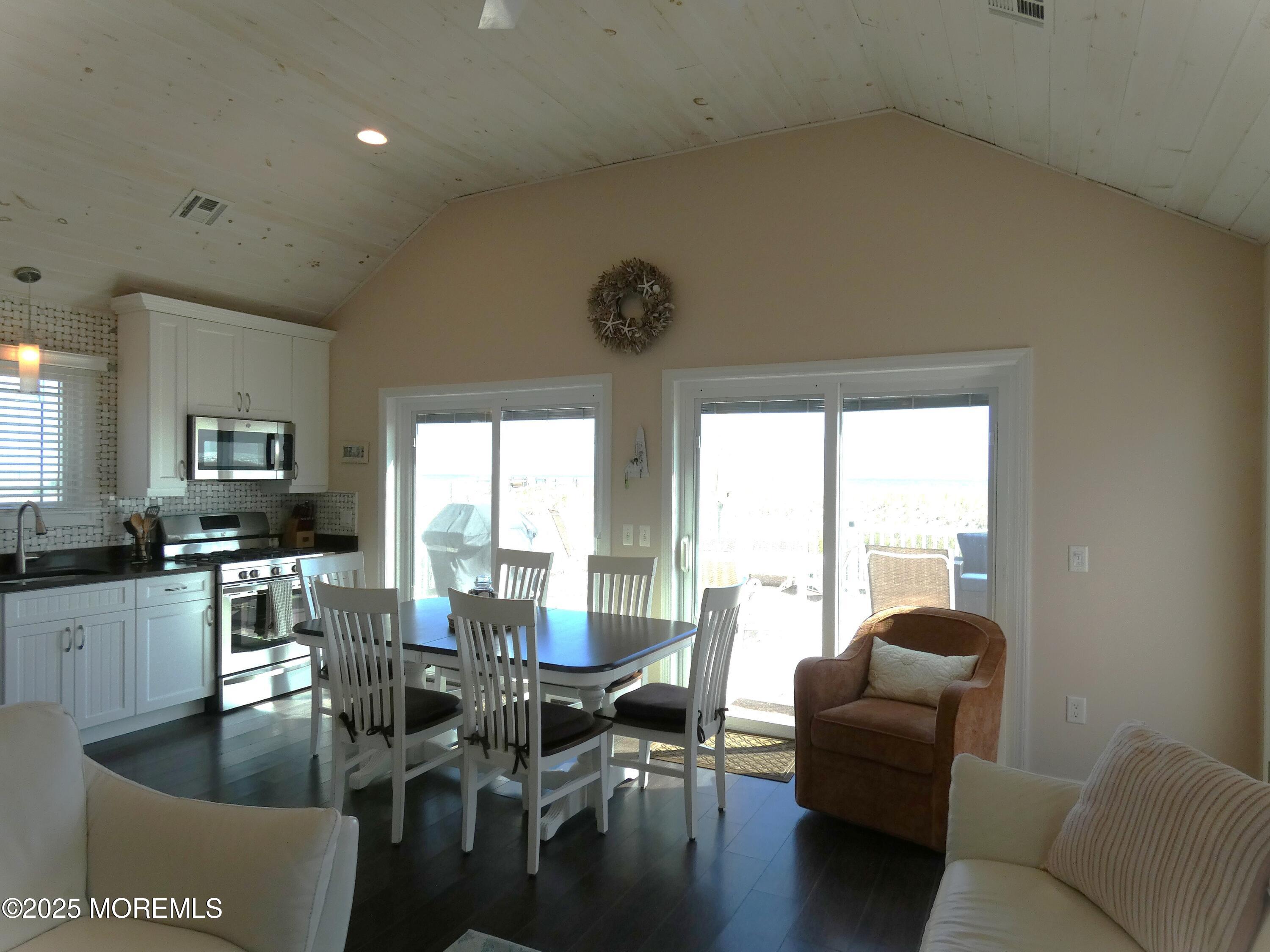 3420 Seaview Road Lavallette, NJ 08735 - Photo 10 of 44 a living room with furniture a large window and a dining table