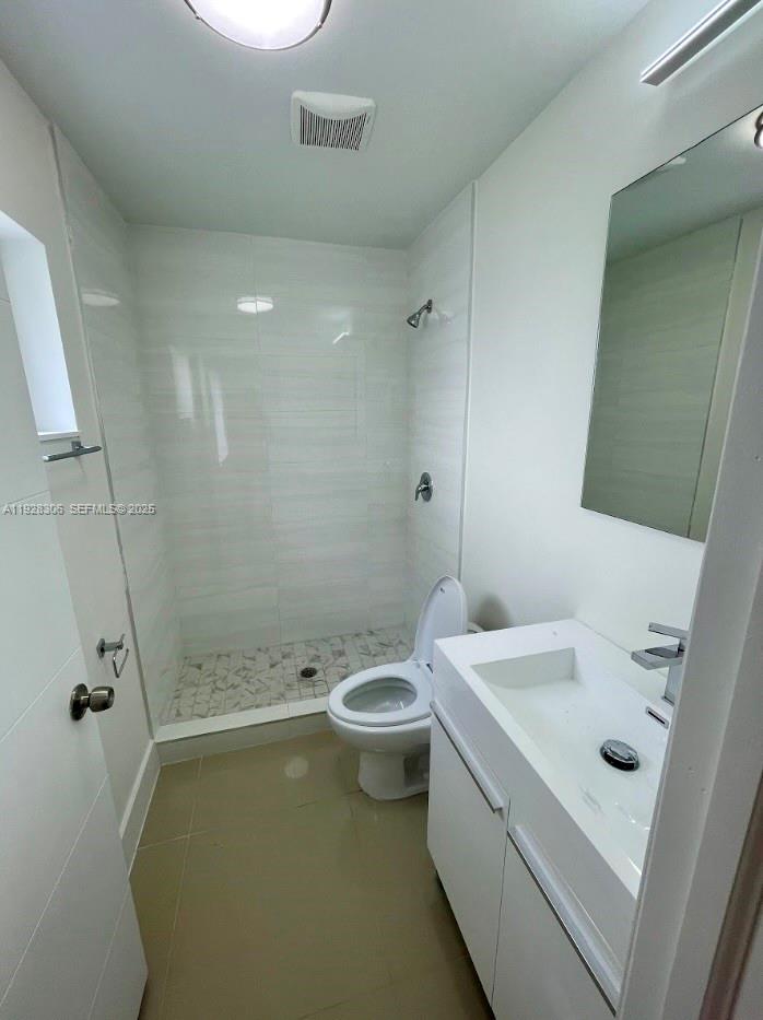 1766 Northwest 68th Terrace, Unit A Miami, FL 33147 - Photo 6 of 10 a bathroom with a sink a toilet and shower