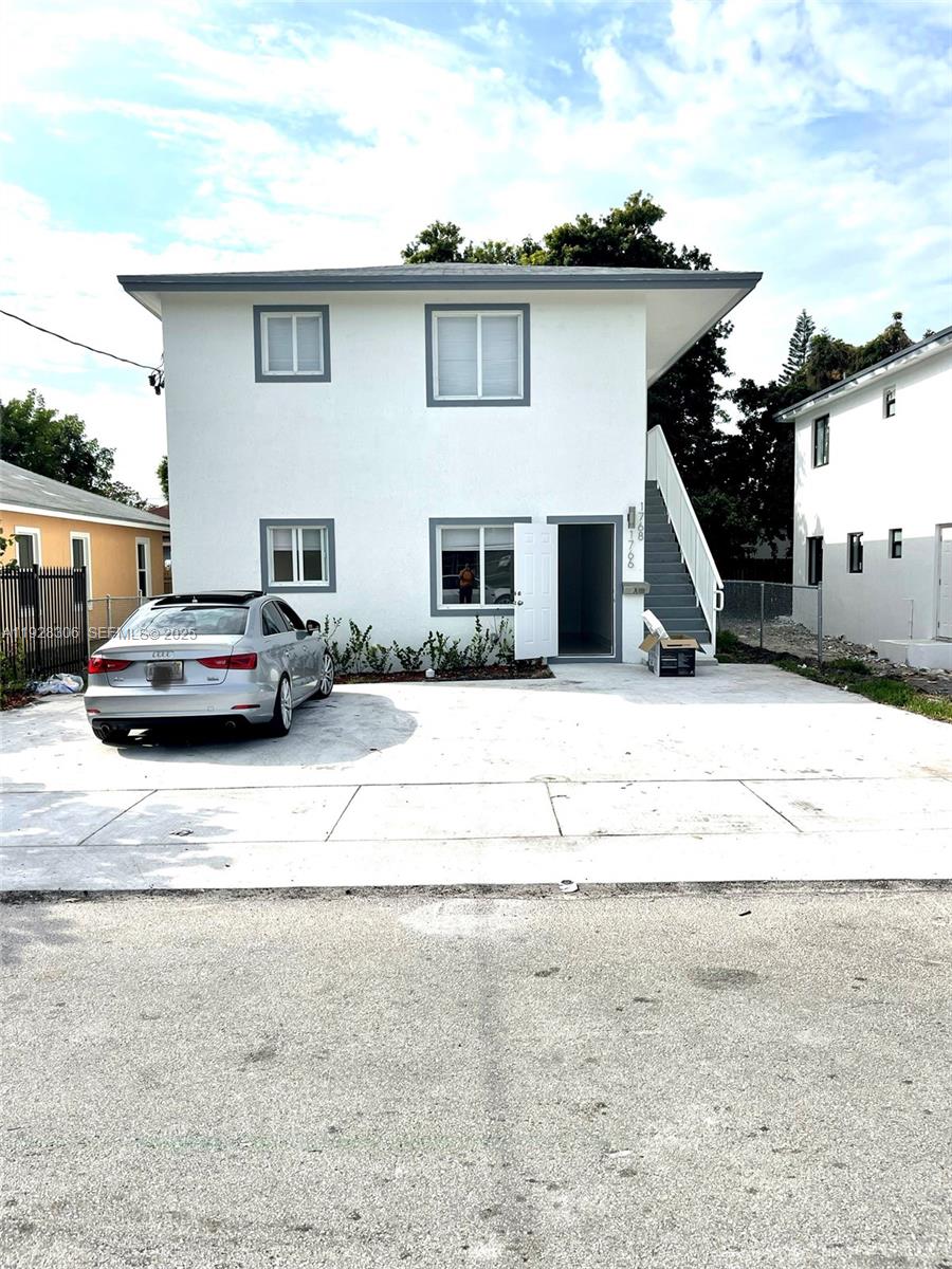 1766 Northwest 68th Terrace, Unit A Miami, FL 33147 - Photo 10 of 10 a white house that has a clock on it