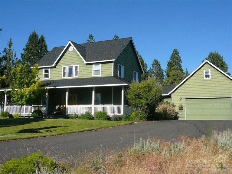60670 Billadeau Road Bend, OR 97702 - Photo 3 of 25 a front view of a house with a yard and trees