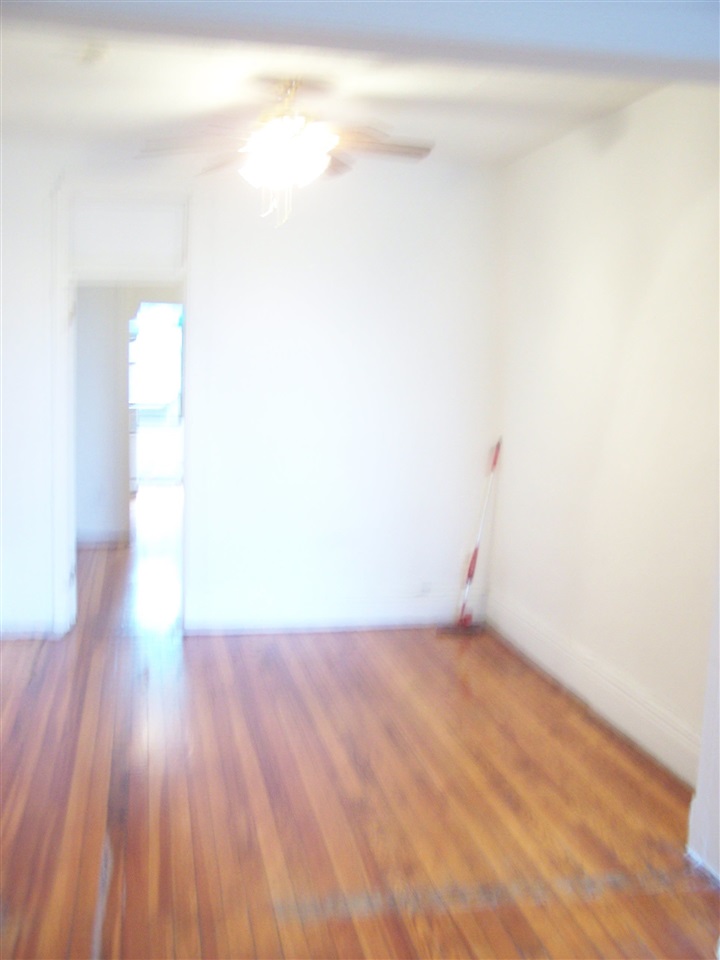 112 14th Street, Unit 3 Hoboken, NJ 07030 - Photo 3 of 10 a view of a small space with wooden floor and a window