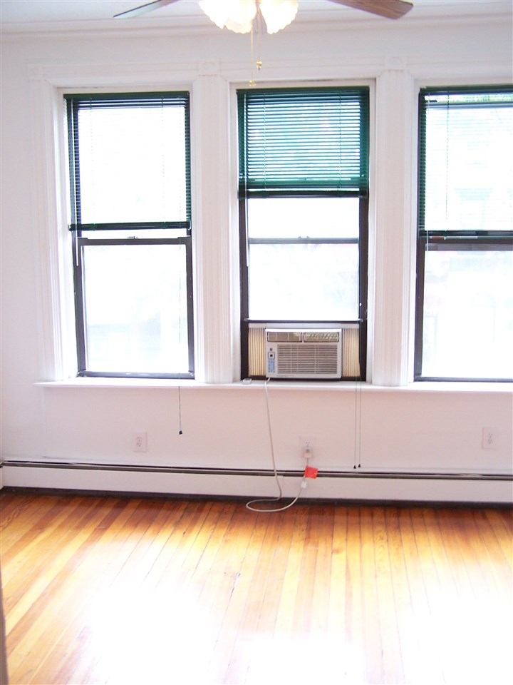 112 14th Street, Unit 3 Hoboken, NJ 07030 - Photo 6 of 10 a view of an empty room with a window
