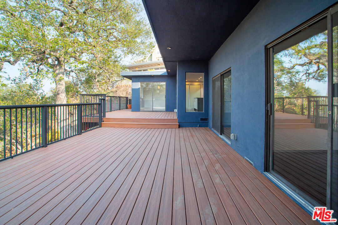 1925 Walcott Way Los Angeles, CA 90039 - Photo 12 of 27 a view of a room with wooden floor and iron stairs