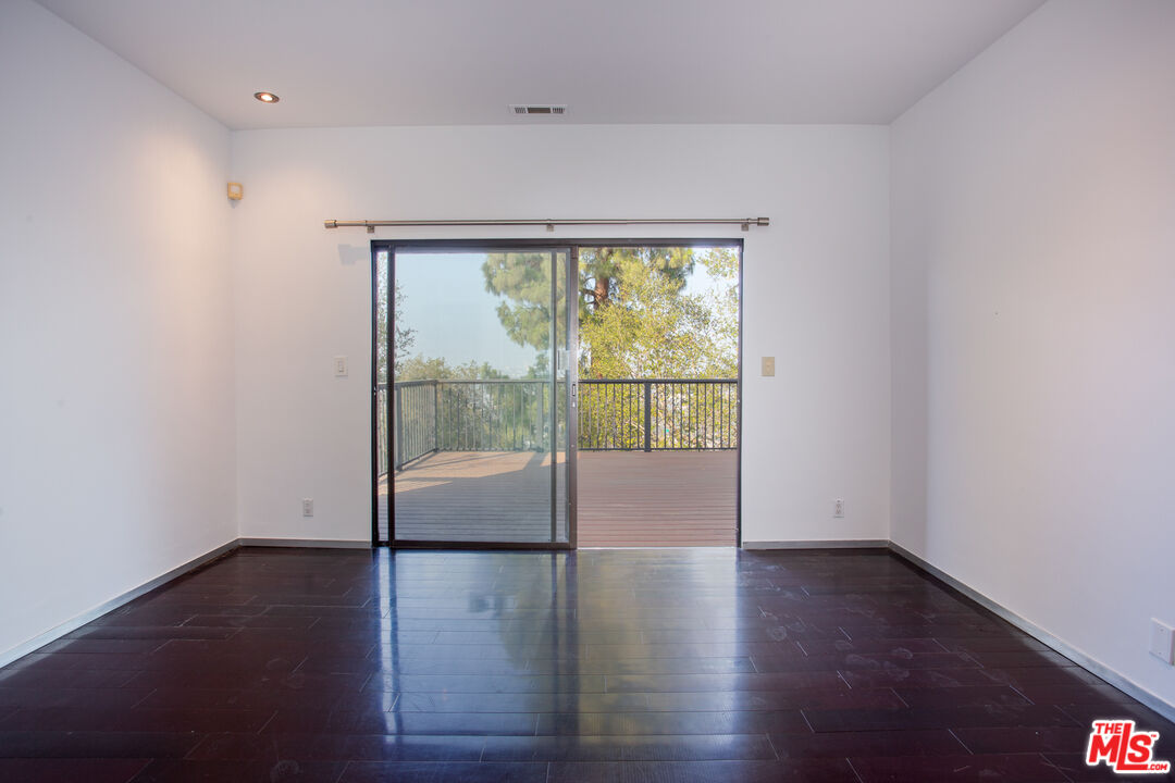 1925 Walcott Way Los Angeles, CA 90039 - Photo 15 of 27 an empty room with wooden floor and windows