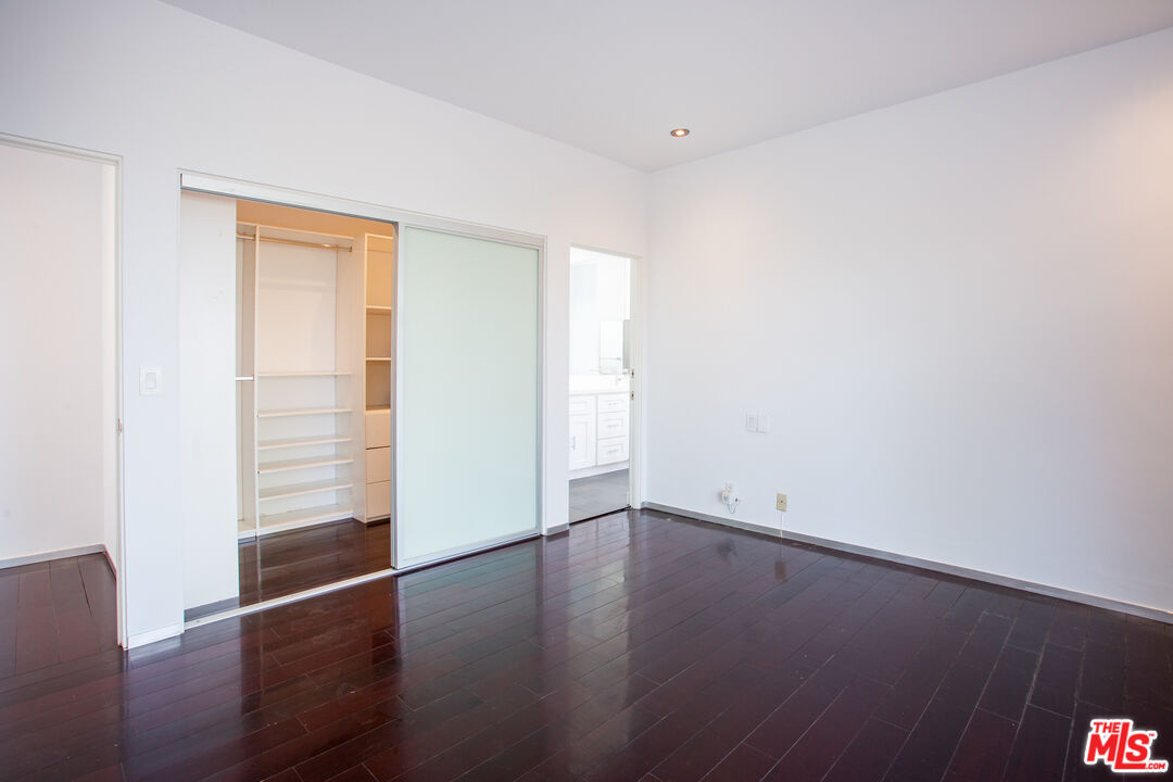 1925 Walcott Way Los Angeles, CA 90039 - Photo 16 of 27 an empty room with wooden floor and windows