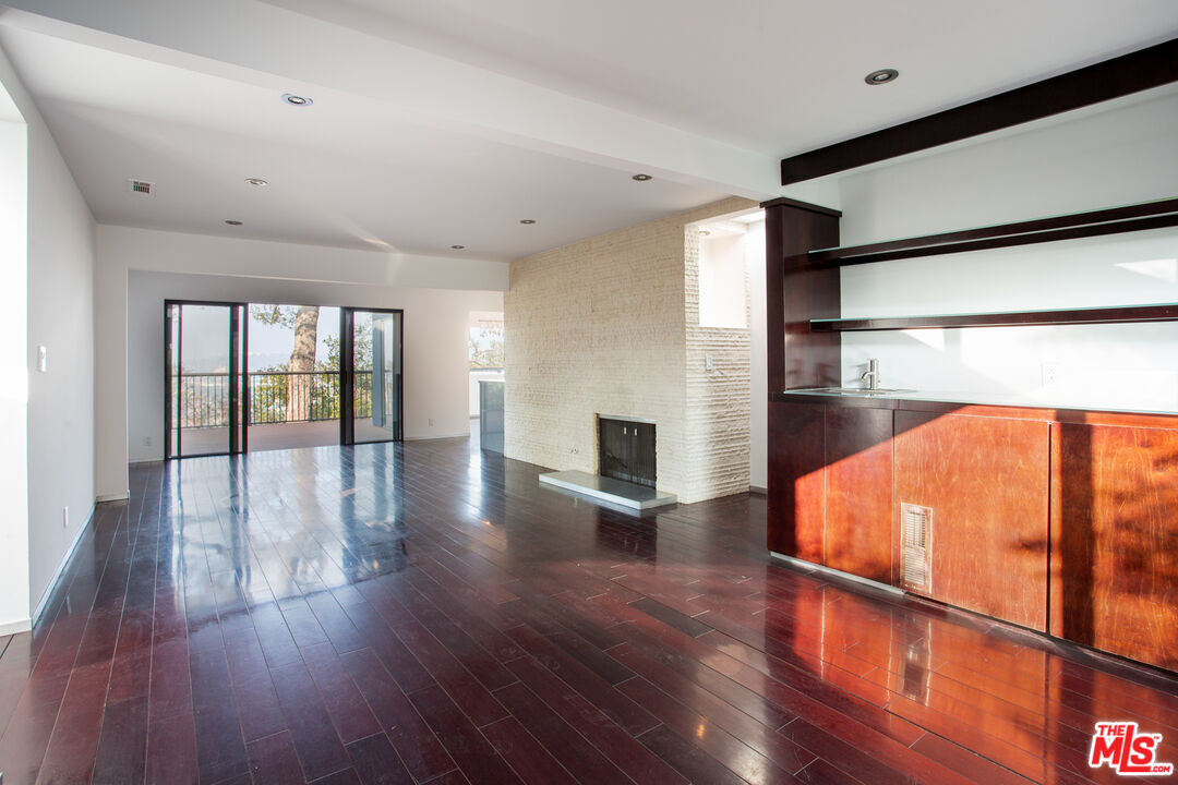 1925 Walcott Way Los Angeles, CA 90039 - Photo 3 of 27 a view of a living room with wooden floor and fireplace