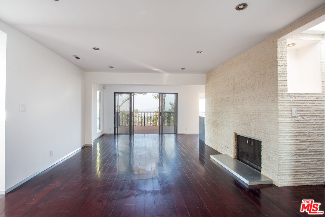 1925 Walcott Way Los Angeles, CA 90039 - Photo 5 of 27 a view of an empty room with wooden floor and a window