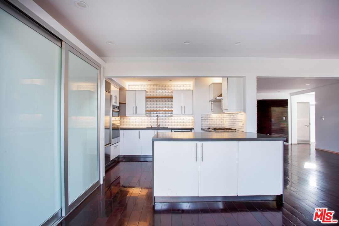 1925 Walcott Way Los Angeles, CA 90039 - Photo 7 of 27 a kitchen with stainless steel appliances granite countertop a refrigerator a sink dishwasher a stove and white countertops with wooden floor