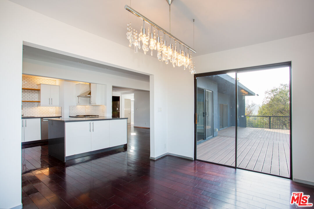 1925 Walcott Way Los Angeles, CA 90039 - Photo 9 of 27 a view of a hallway with wooden floor and a living room