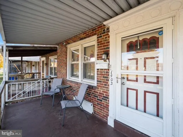a balcony with furniture and a gate
