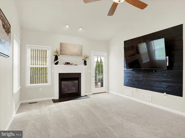 a living room with a fireplace and a flat screen tv