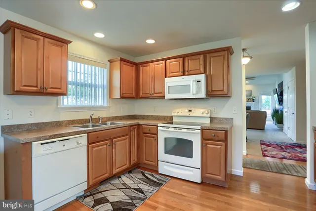 a kitchen with stainless steel appliances granite countertop a stove sink and cabinets