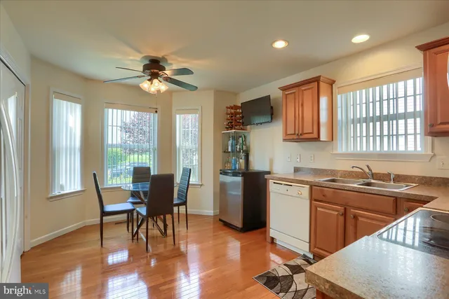 a kitchen with a table chairs refrigerator and microwave