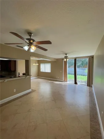 a view of a livingroom with a ceiling fan and window