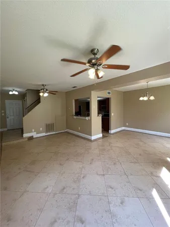 a view of a livingroom with a ceiling fan and window