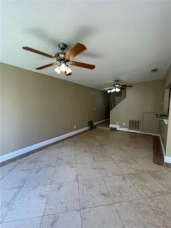 a view of a room with a ceiling fan
