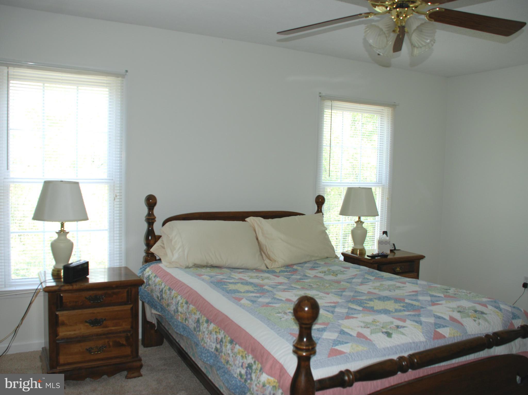 12375 Old Stillhouse Road Boston, VA 22713 - Photo 14 of 30 a bed sitting in a bedroom next to a window