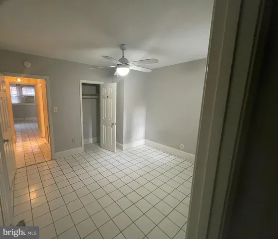 a view of an empty room and bathroom