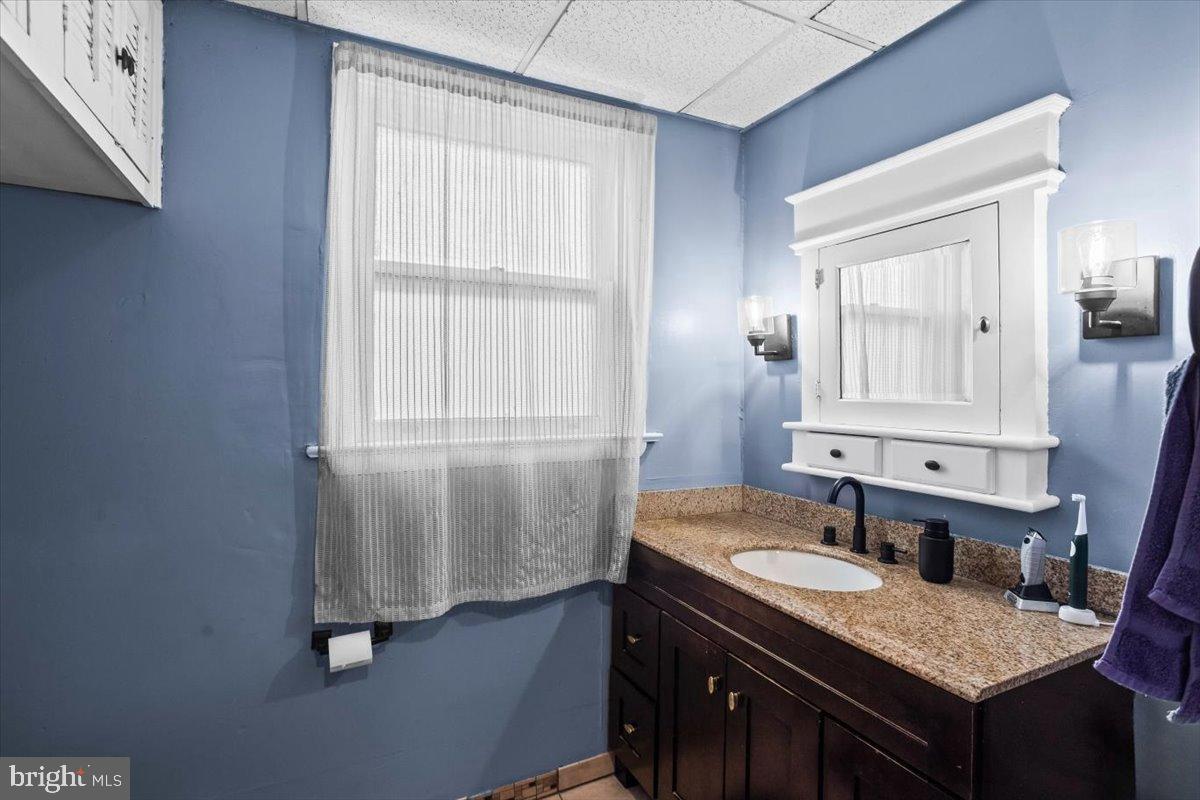 128 East Ross Street Lancaster, PA 17602 - Photo 21 of 36 a bathroom with a granite countertop sink and a mirror