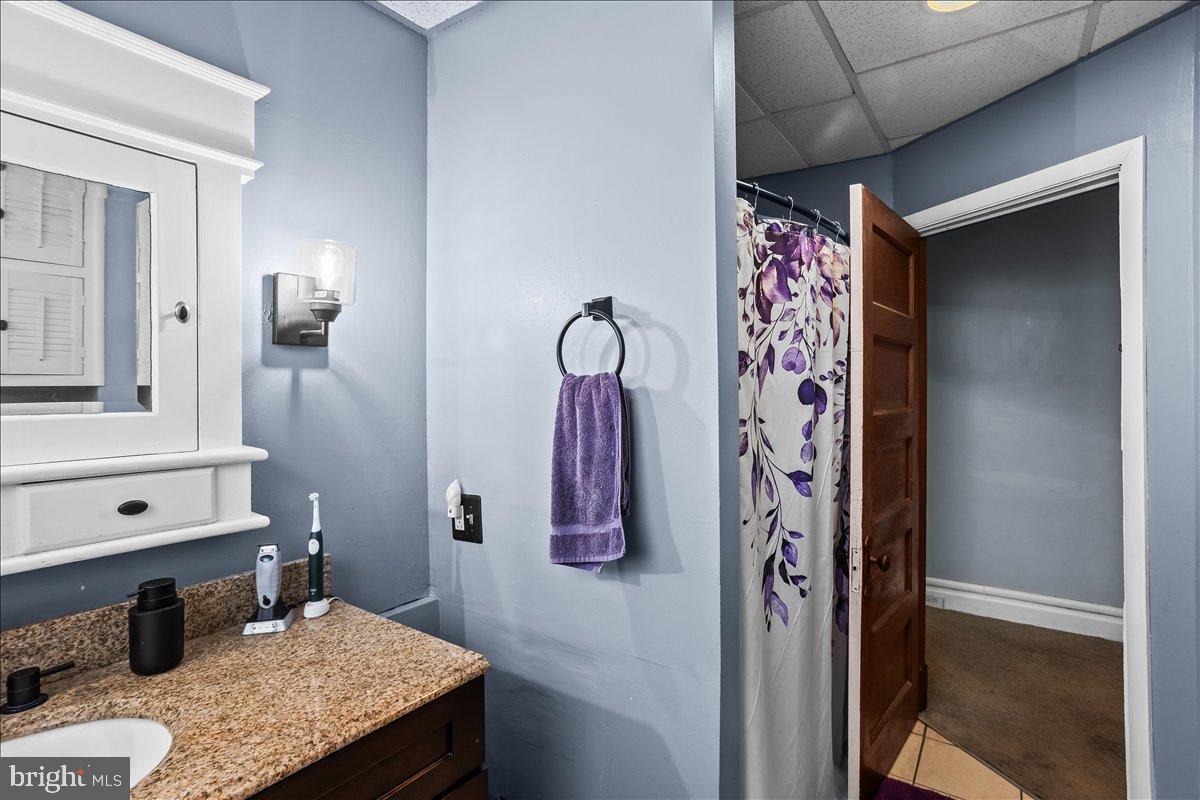 128 East Ross Street Lancaster, PA 17602 - Photo 22 of 36 a bathroom with a granite countertop sink and a mirror