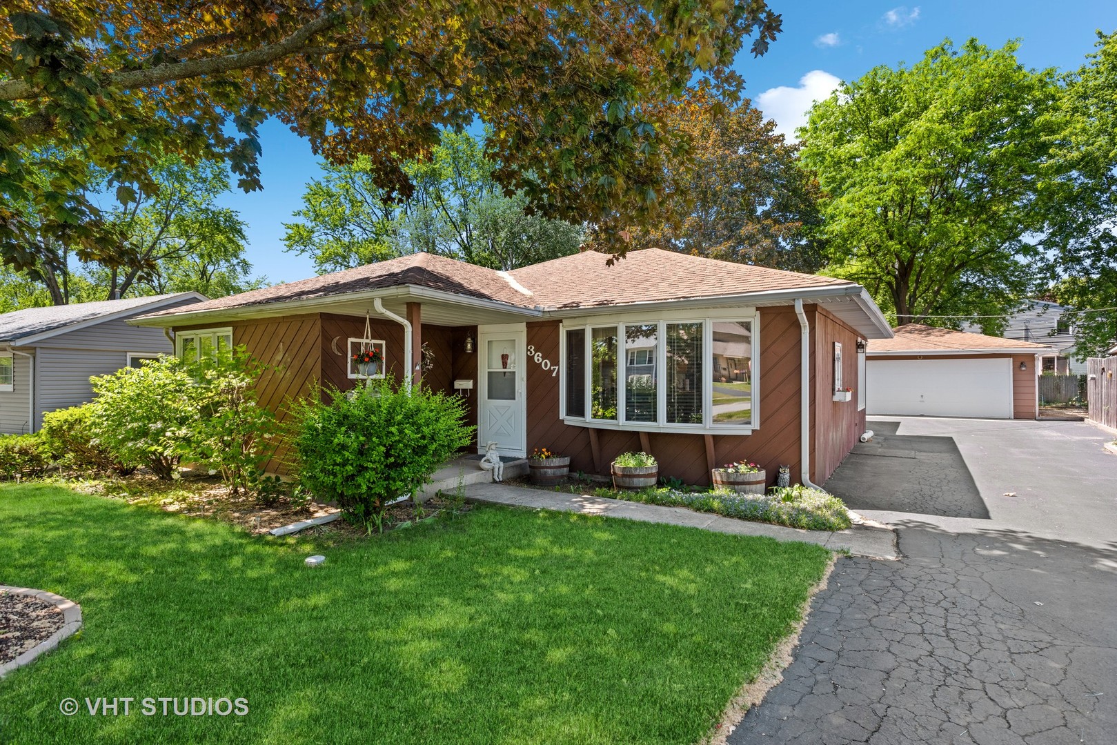 a front view of a house with a garden and porch