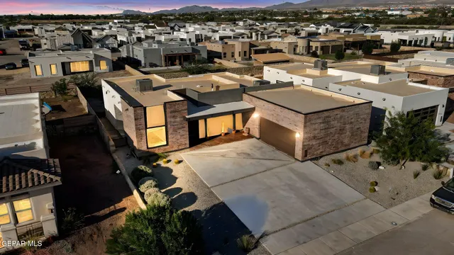 an aerial view of a houses with a city view