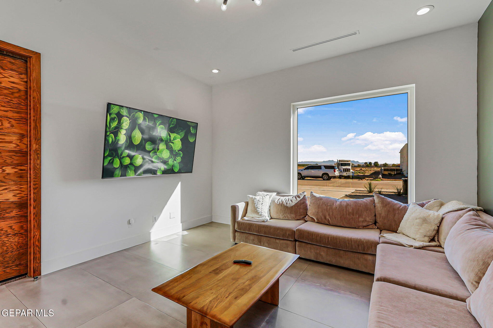 329 Rio Del Rancho Court El Paso, TX 79932 - Photo 11 of 52 a living room with furniture and a flat screen tv
