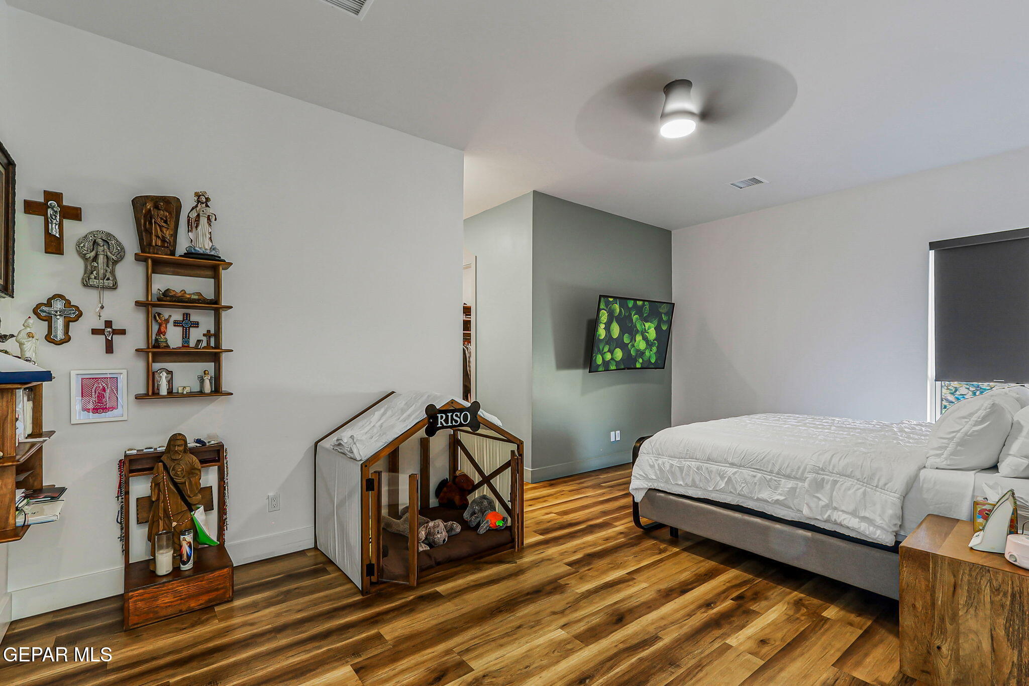 329 Rio Del Rancho Court El Paso, TX 79932 - Photo 23 of 52 a bedroom with a bed and wooden floor