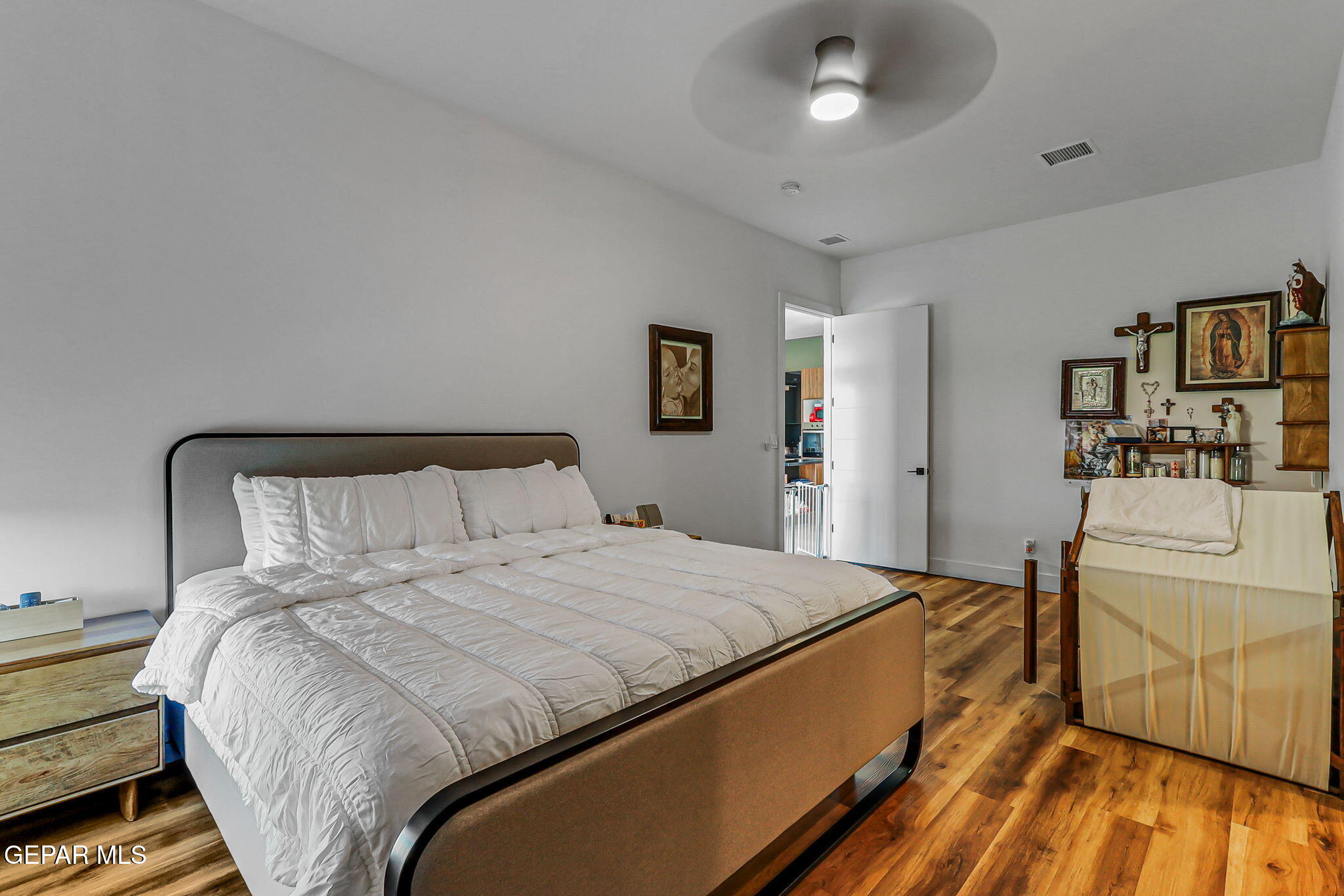 329 Rio Del Rancho Court El Paso, TX 79932 - Photo 25 of 52 a bedroom with a bed and wooden floor