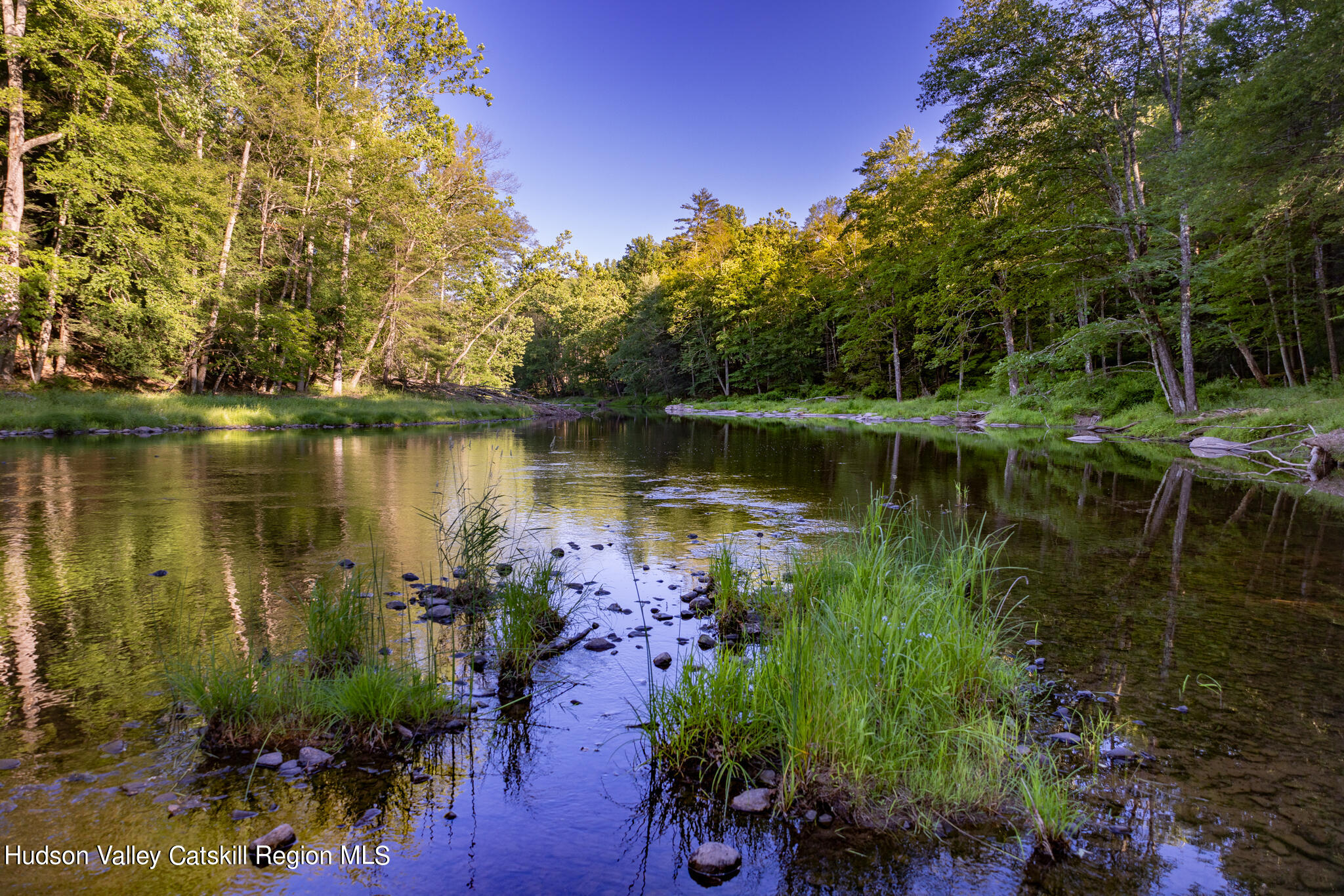 4049 Atwood Road, Unit END OF GERWIN ROAD Stone Ridge, NY 12484 - Photo 20 of 30 a view of a lake with a house in the background