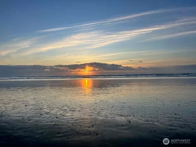 a view of a house with wooden fence