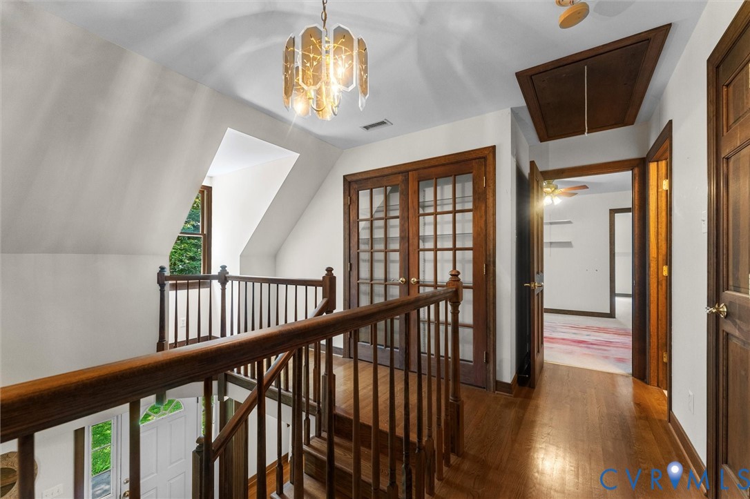 124 Gammons View Bumpass, VA 23024 - Photo 27 of 35 Corridor with dark wood finished floors, attic acc