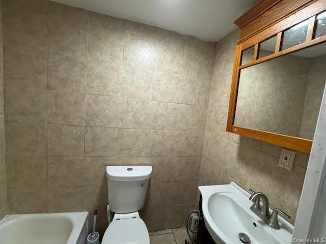 a white toilet sitting next to a bathroom sink