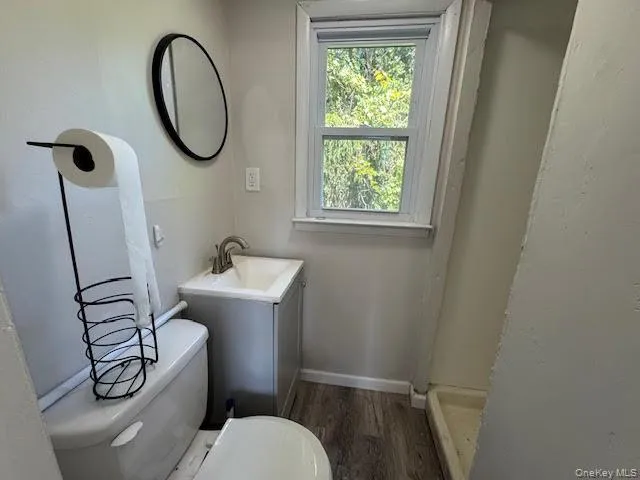 a bathroom with a sink toilet and a mirror