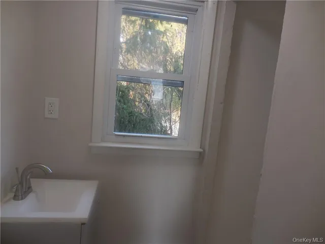 a bathroom with a sink and a window