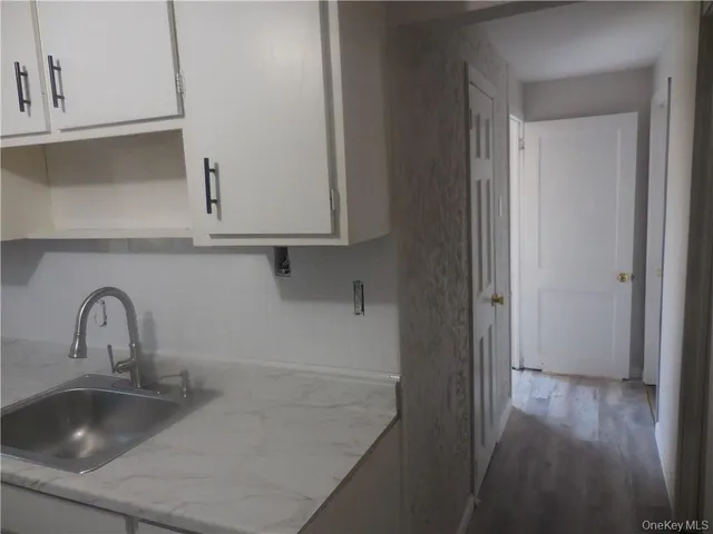 a kitchen with a sink and cabinets