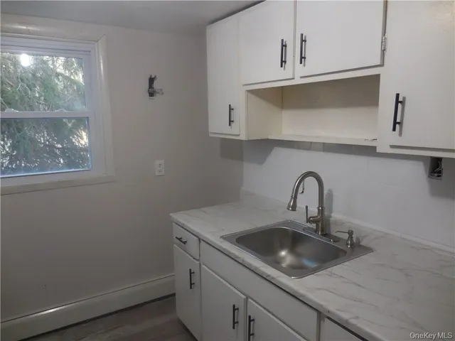 a close view of a sink a faucet and appliance in the kitchen