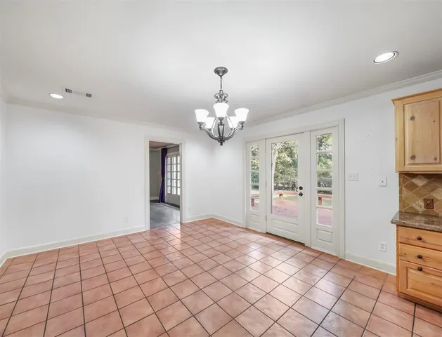 a view of an empty room with a cabinet
