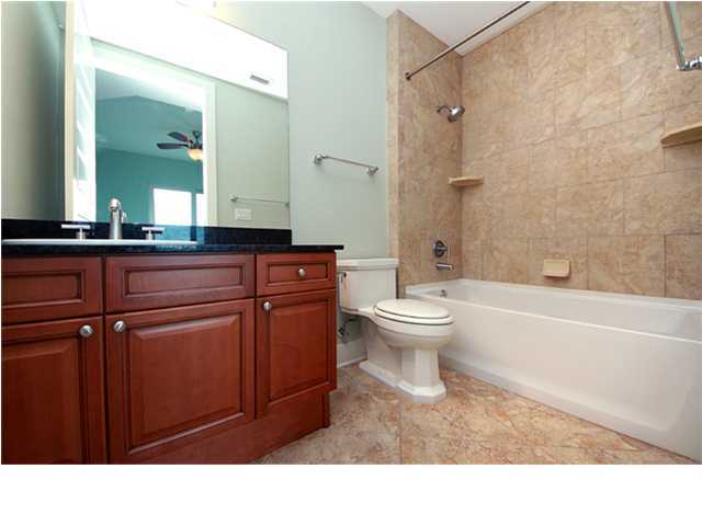 211 Durango Road, Unit 517 Destin, FL 32541 - Photo 12 of 28 a bathroom with a sink a toilet a mirror and shower