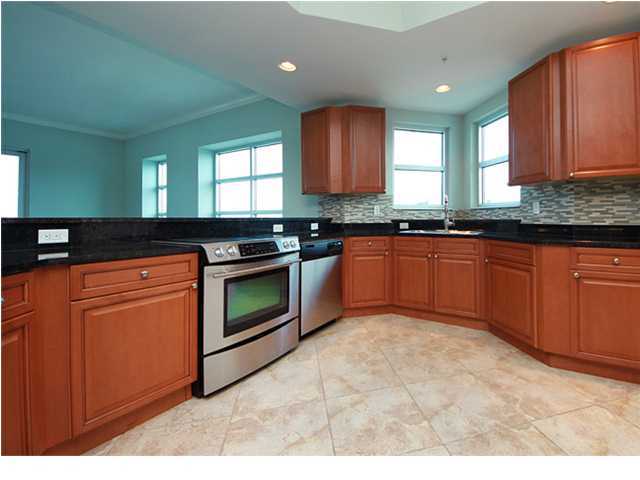 211 Durango Road, Unit 517 Destin, FL 32541 - Photo 6 of 28 a kitchen with stainless steel appliances granite countertop a stove a sink and a microwave