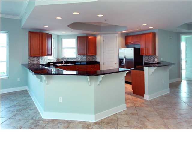 211 Durango Road, Unit 517 Destin, FL 32541 - Photo 7 of 28 a kitchen with stainless steel appliances kitchen island granite countertop a stove and a sink