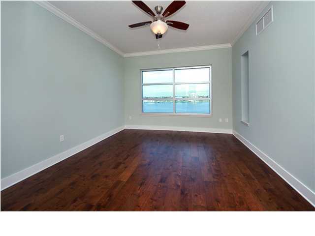 211 Durango Road, Unit 517 Destin, FL 32541 - Photo 8 of 28 a black and white kitchen with wooden floor