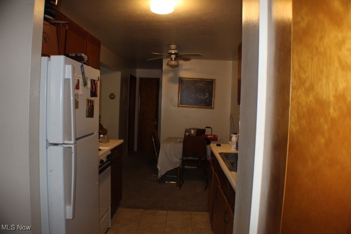 5378 Lee Road Maple Heights, OH 44137 - Photo 5 of 10 Kitchen with tile patterned floors, ceiling fan, and white refrigerator