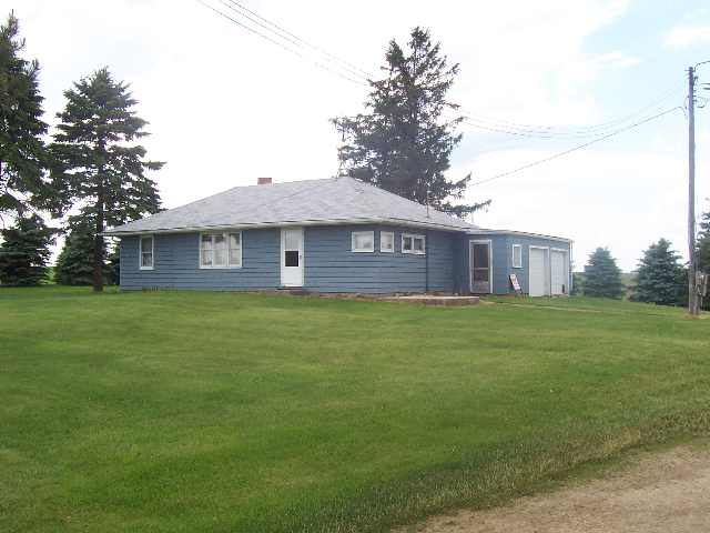 13072 West Warren Road Winslow, IL 61089 - Photo 1 of 4 a front view of a house with a garden