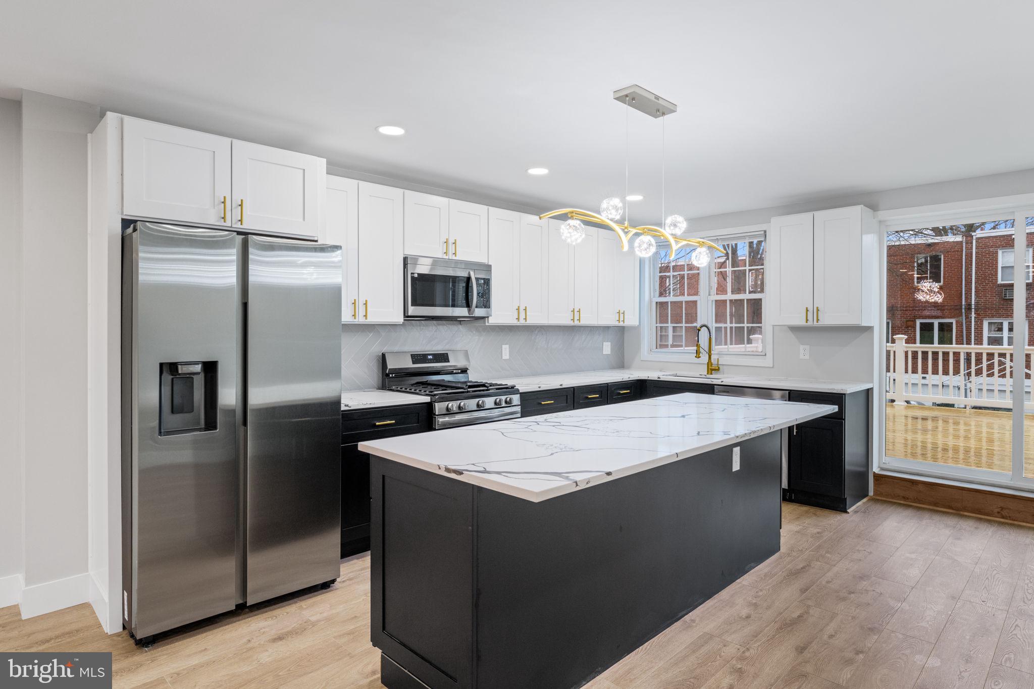 8546 Forrest Avenue Philadelphia, PA 19150 - Photo 12 of 56 a large kitchen with stainless steel appliances granite countertop a stove a sink dishwasher and a refrigerator