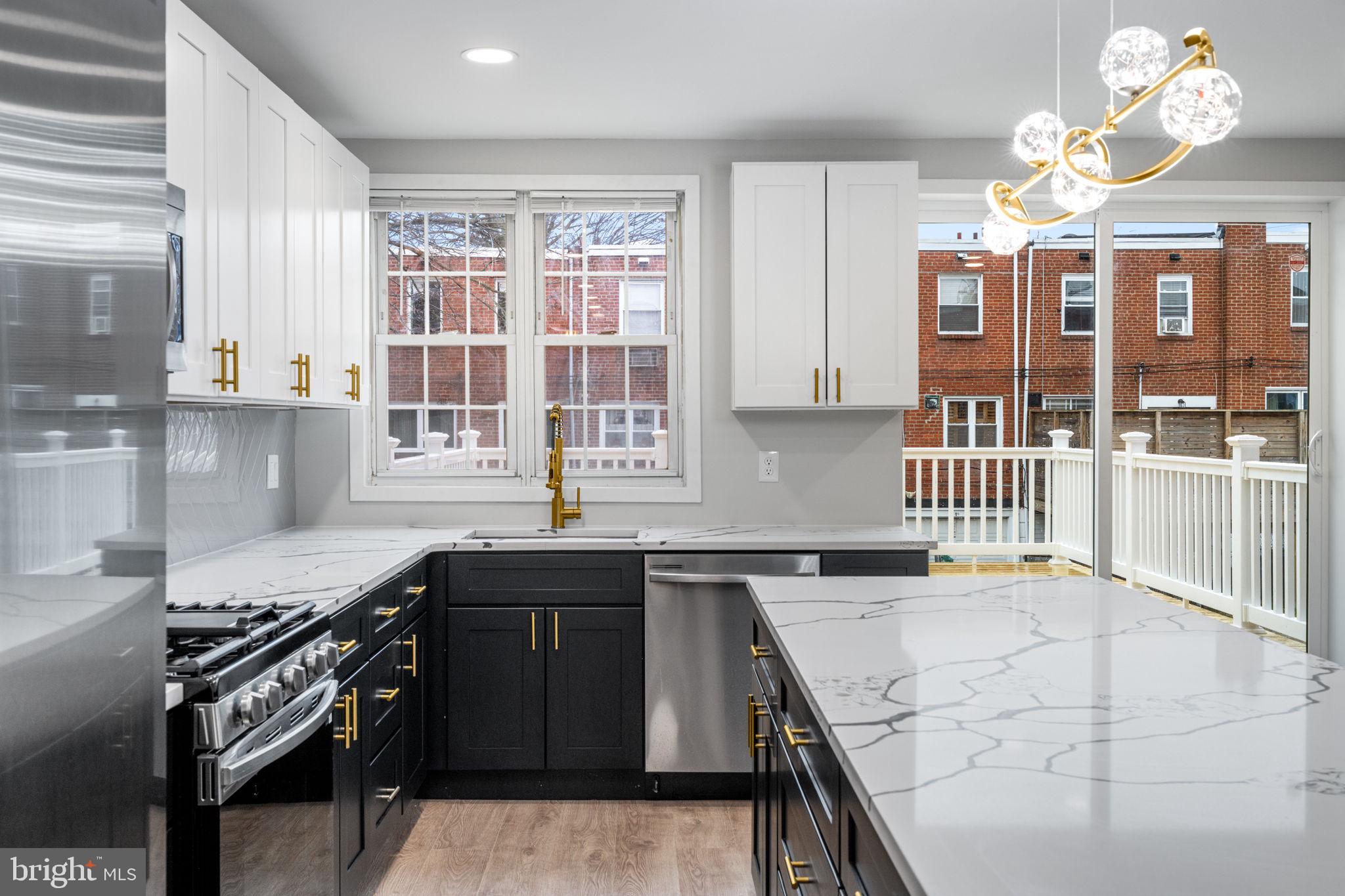 8546 Forrest Avenue Philadelphia, PA 19150 - Photo 14 of 56 a kitchen with stainless steel appliances granite countertop a sink stove and cabinets