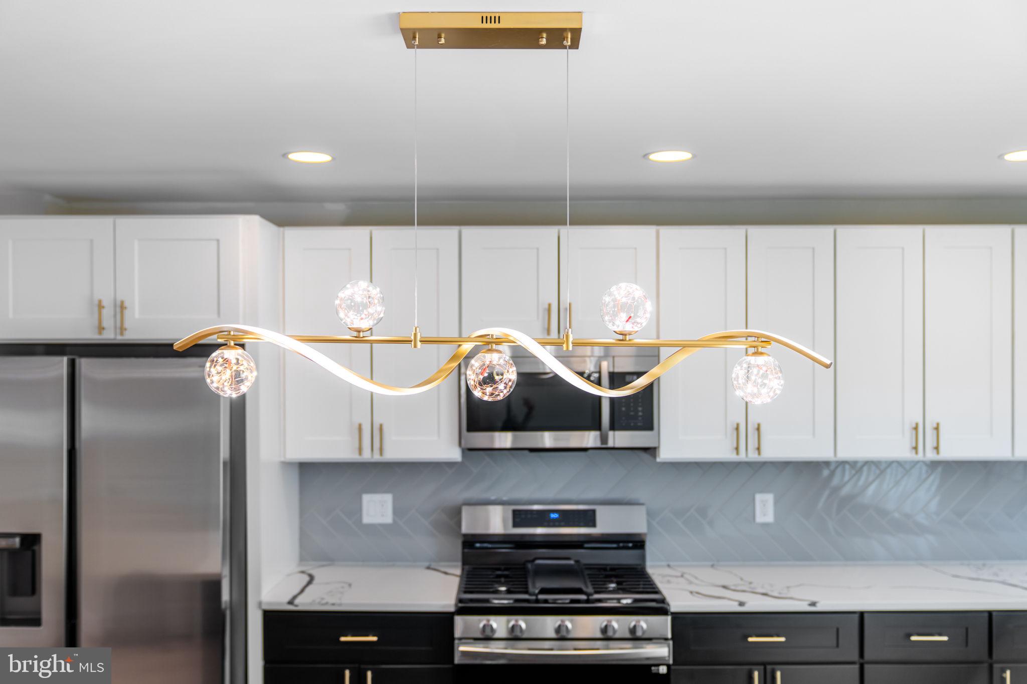 8546 Forrest Avenue Philadelphia, PA 19150 - Photo 16 of 56 a kitchen with stainless steel appliances granite countertop a stove a sink and a refrigerator