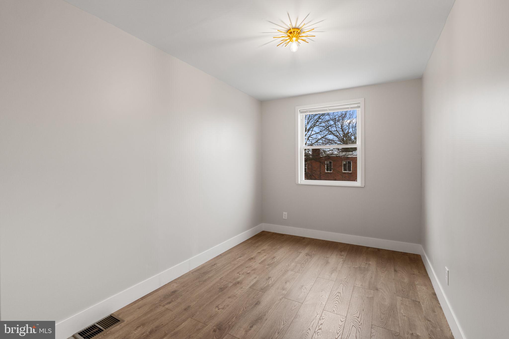 8546 Forrest Avenue Philadelphia, PA 19150 - Photo 31 of 56 an empty room with a window and a painting on the wall