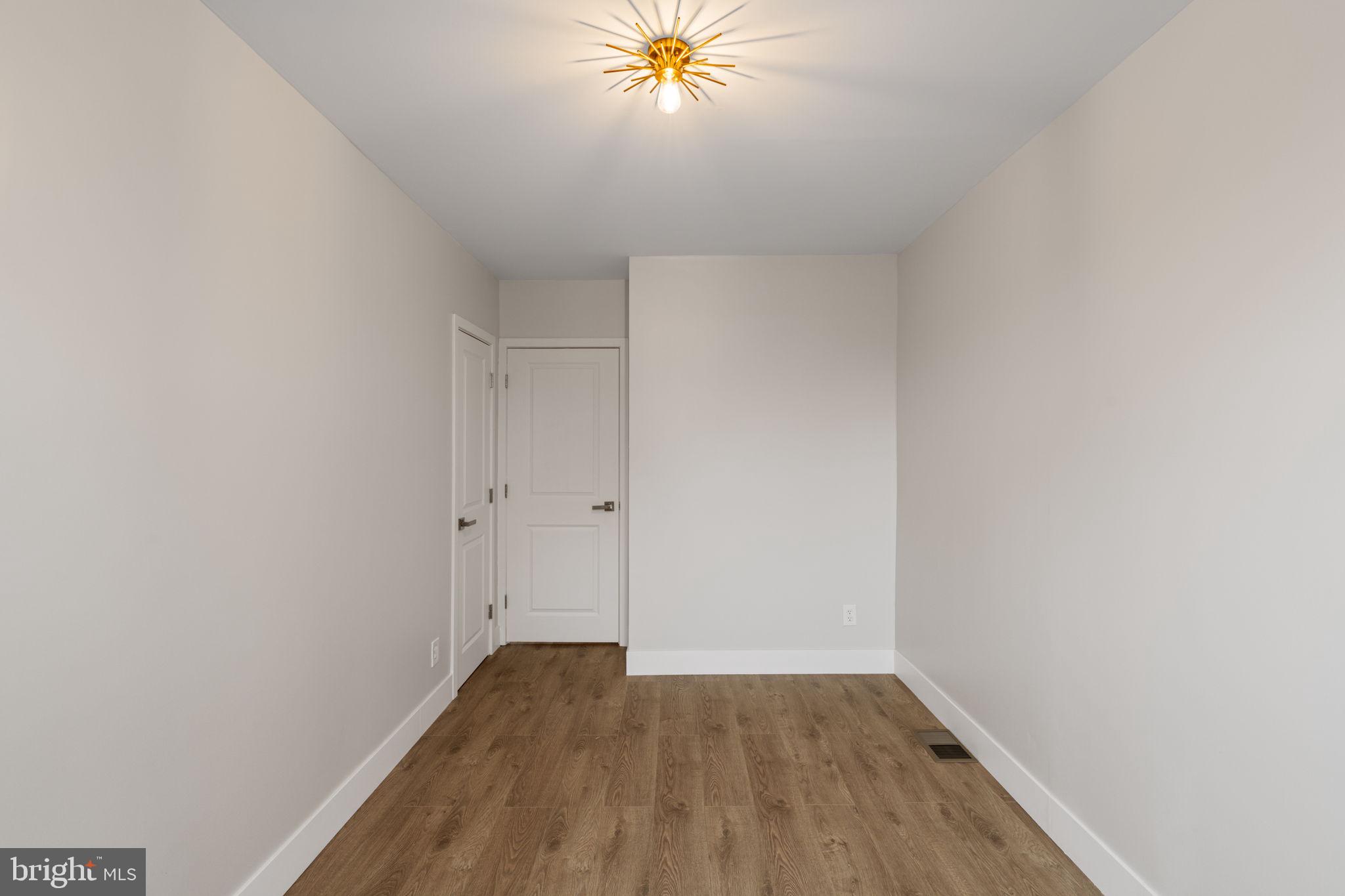 8546 Forrest Avenue Philadelphia, PA 19150 - Photo 32 of 56 a view of a room with wooden floor and a ceiling fan